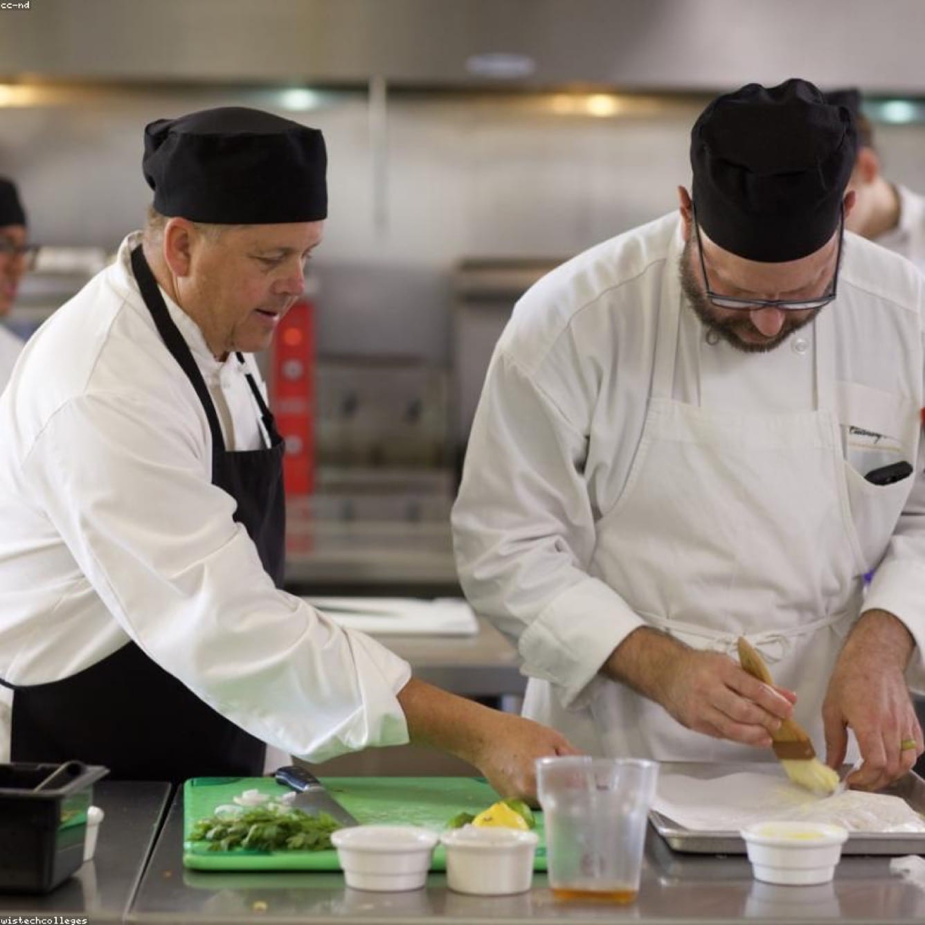 Cloud kitchen staff packing meals into paper trays for dispatch