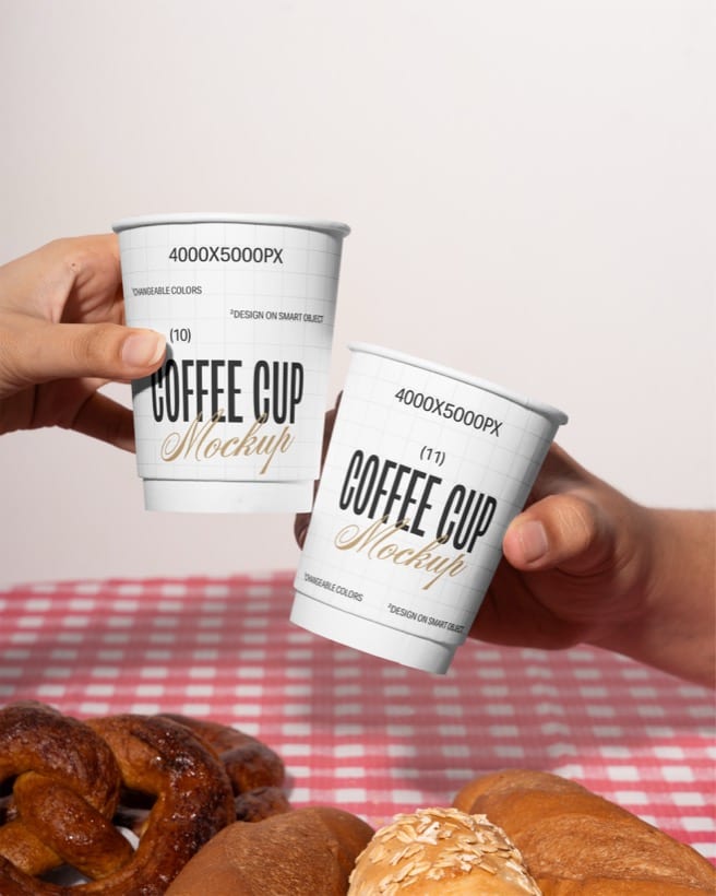 Custom-printed paper cups toasted over a caf&eacute; table